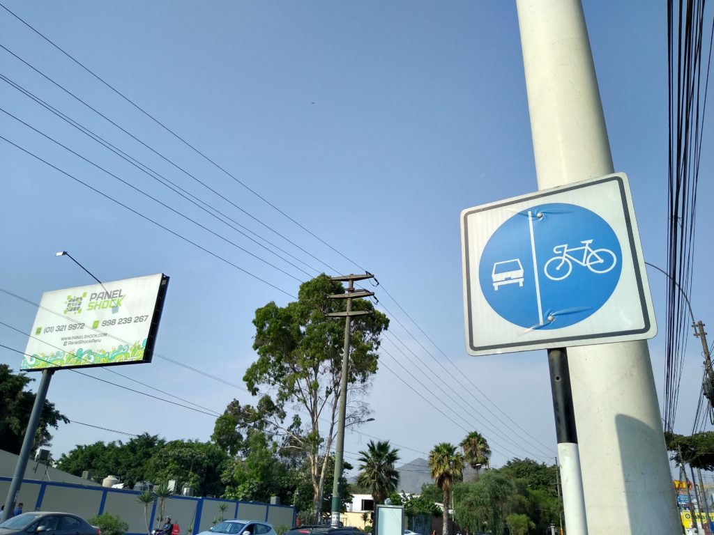 sign showing bike lanes next to lanes for vehicles