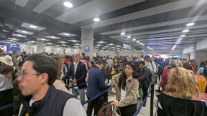Travelers arriving at passport control at Jorge Chávez International Airport