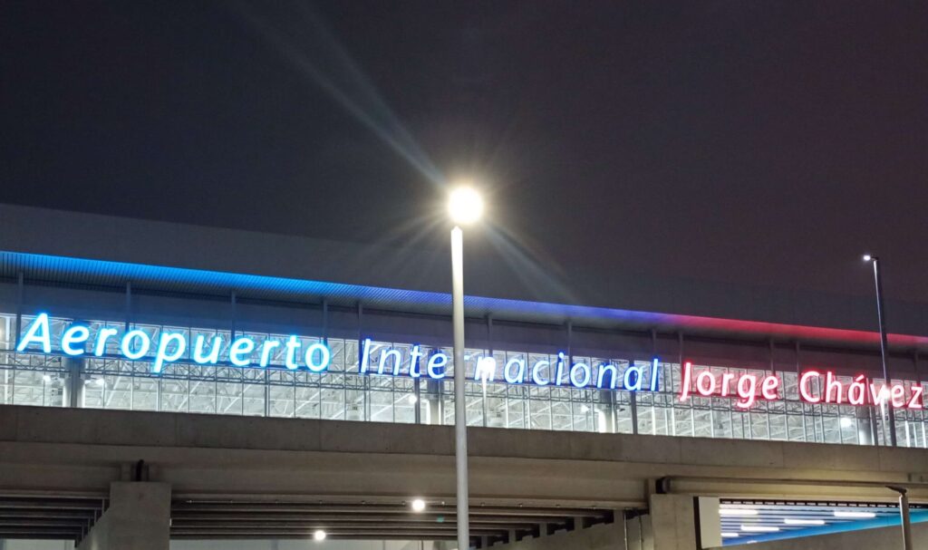 Nighttime photo of the new Lima Airport terminal sign taken by a local airport taxi driver, showing travelers the updated terminal entrance in 2025.
