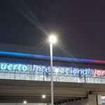 Exterior of the Jorge Chavez International Airport in Lima Peru, with lighted signage